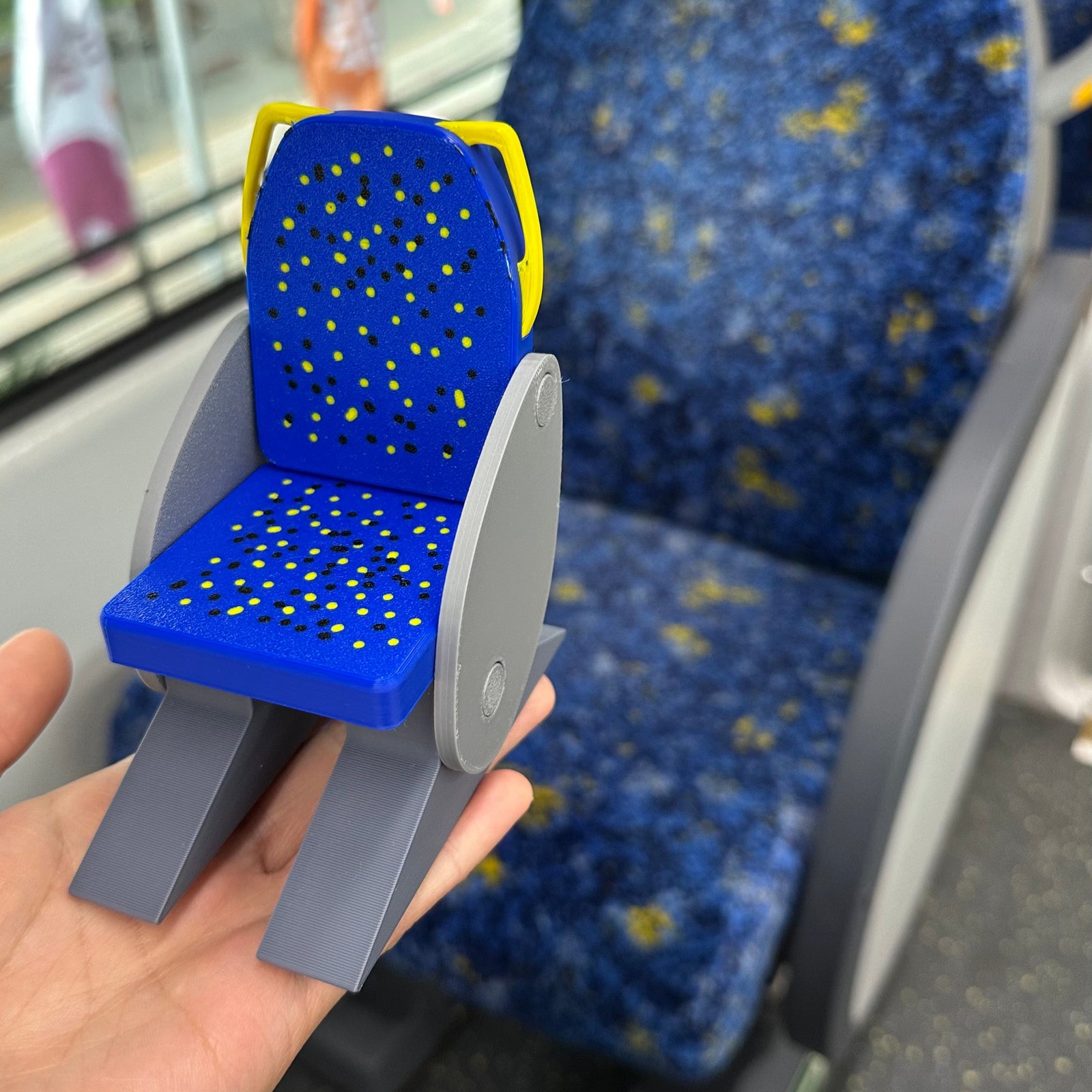 Miniature 3D printed Sydney train seat keepsake by Sliced 3D Print, with the signature blue speckled upholstery and a working flip-up seat